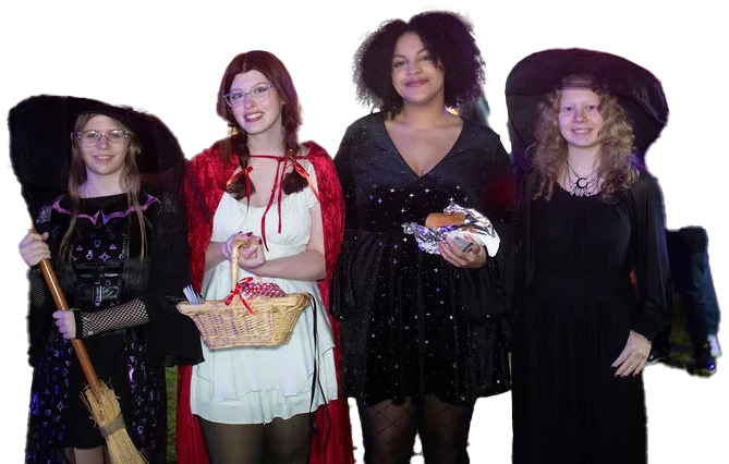 Four guests in costume from last year: a witch with a broom, Little Red Riding Hood, a woman in a starry black dress and a witch in a wide black hat