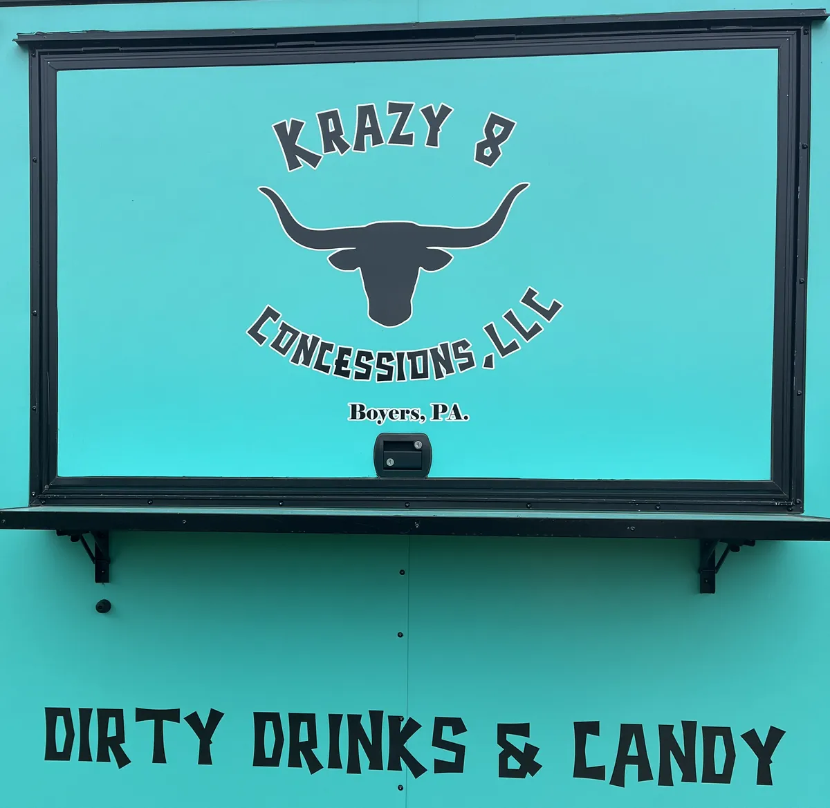 The Krazy 8 Concessions trailer window, lettered Dirty Drinks & Candy